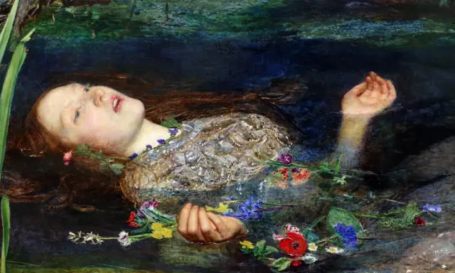 A Pre-Raphaelite masterpiece depicts Ophelia floating serenely in water, her face pale, surrounded by a wreath of flowers.