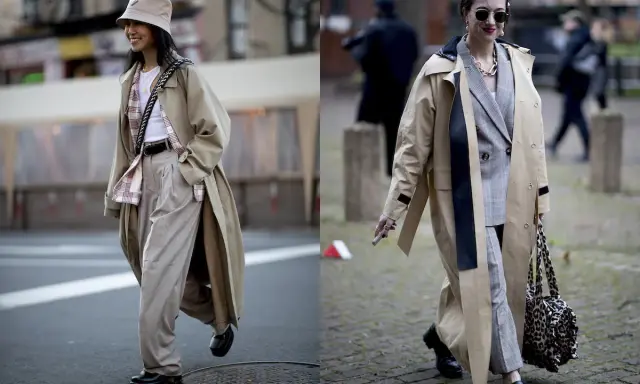 Due donne con trench eleganti. La prima con cappello a secchiello e pantaloni ampi, la seconda con blazer a quadri. Si può mettere il trench di sera per un look chic.