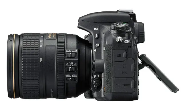 Nikon D750 test: aparat z obiektywem 24-120 mm, widoczne przyciski sterowania, Wi-Fi, HDMI i wejście mikrofonowe.