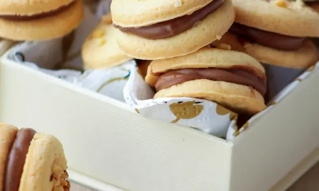 Des biscuits sablés garnis d'une crème au chocolat onctueuse, parfaits pour une pause gourmande.