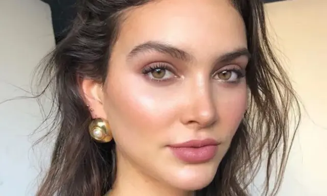 Maquillaje invitada boda ojos marrones. Piel luminosa, labios rosados y pendientes dorados.