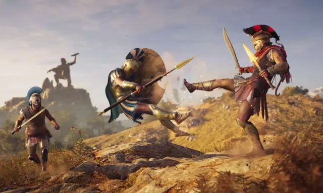 Spartanie walczą w Assassin's Creed Odyssey. Jeden z nich wykonuje kopnięcie, drugi blokuje tarczą.