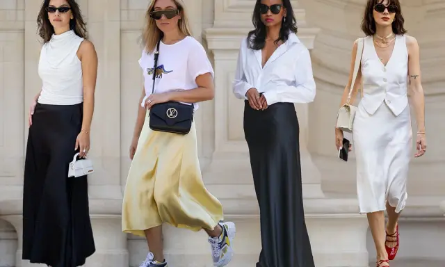 Four women in stylish outfits featuring satin skirts in black, yellow, and white.