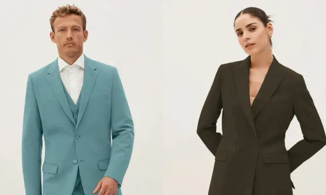 Man in teal single-breasted suit with vest, woman in dark green double-breasted blazer.