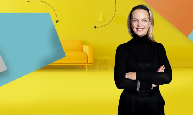 Frau mit Armen verschränkt vor gelbem Hintergrund mit Sofa und Beistelltisch. Inspiration für Renovierungs Serien Deutsch.