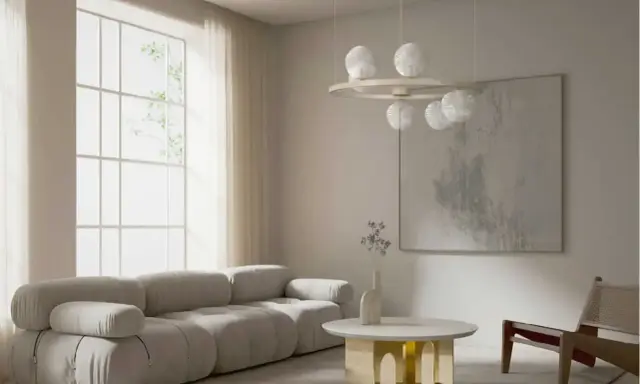 Nowoczesny salon z szarą sofą, okrągłym stolikiem i lampą z kulistymi kloszami w stylu art deco.