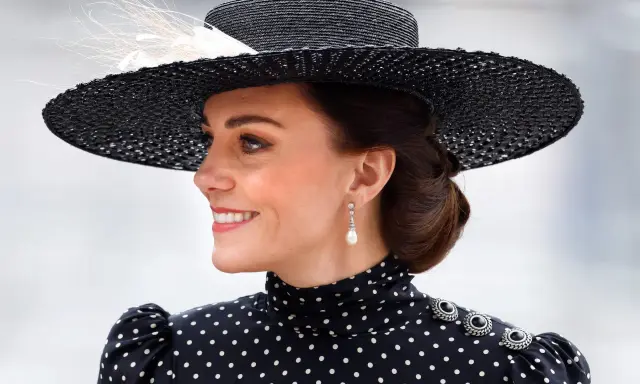 Księżna Kate w eleganckiej, czarno-białej sukience w grochy i stylowym kapeluszu.