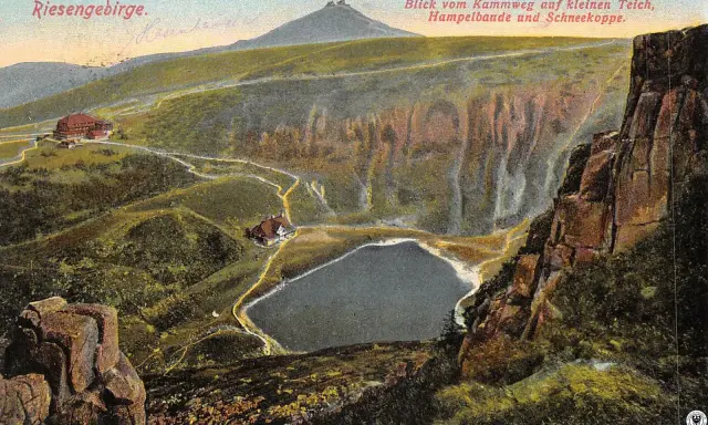 Widok na kocioł wielkiego stawu, z górami i schroniskami. W oddali widać Śnieżkę.