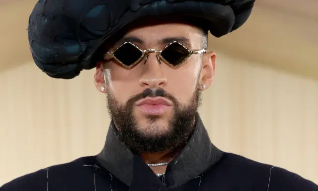 Bad Bunny at the Met Gala, sporting diamond-shaped sunglasses and a dramatic black hat.