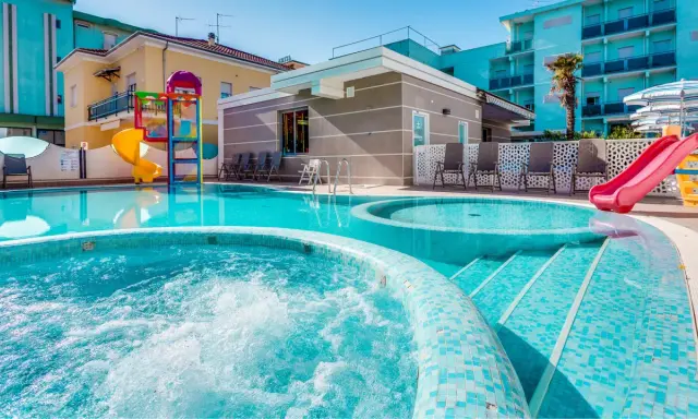 Piscine scintillanti e scivoli colorati in un adriatico family village, perfetti per il divertimento di tutta la famiglia.