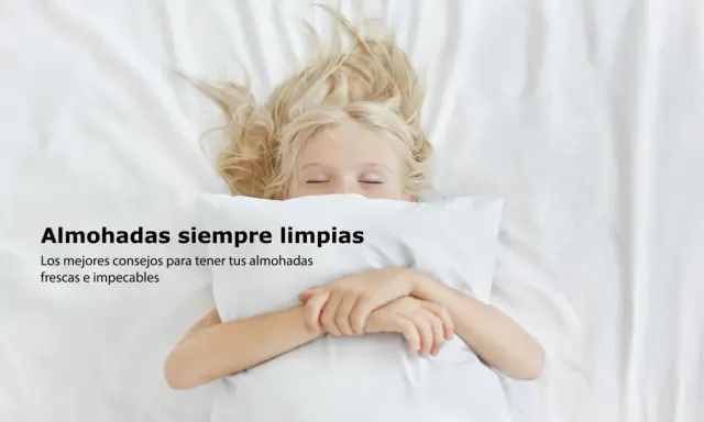 Niña rubia duerme abrazada a una almohada blanca. Consejos sobre como lavar almohadas para que estén frescas e impecables.