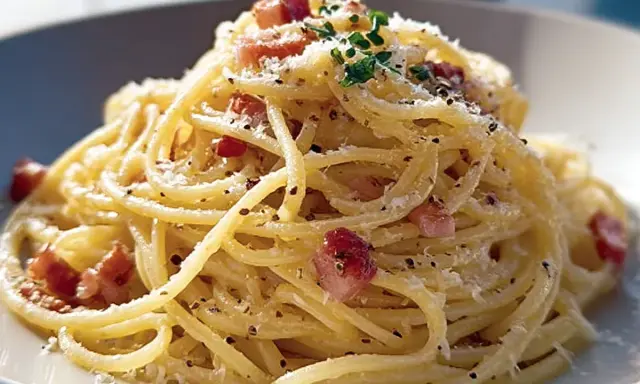 En krämig portion pasta carbonara med guanciale, parmesan och svartpeppar.