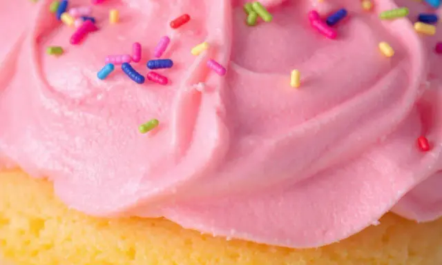 Glaçage cupcake sans beurre rose vif, parsemé de vermicelles colorés. Un délice léger et festif !