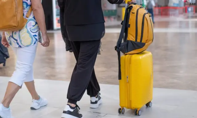 Podróżni z bagażami, zastanawiają się, czy w samolocie jest zimno.