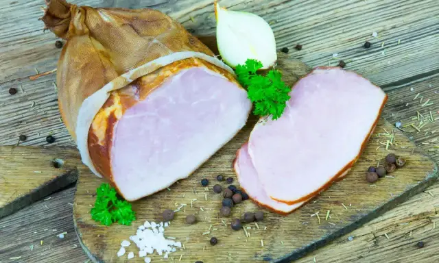Wędzony kindziuk, czyli wieprzowa szynka, pokrojona na plastry, z cebulą i natką pietruszki.
