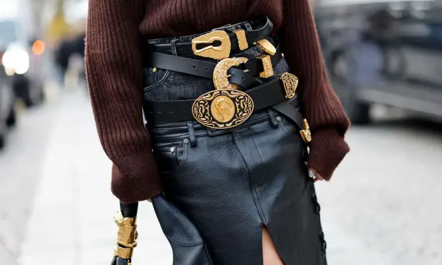 Layered black belts with ornate gold buckles make a bold statement, proving belts are definitely in style.