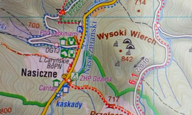 Mapa turystyczna Bieszczadów z zaznaczonymi szlakami, punktami widokowymi i jaskiniami. Widoczne nazwy: Nasiczne, Wysoki Wierch, Pod Jaskiniami.