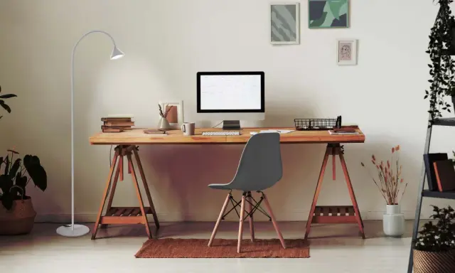 Bureau moderne pour le télétravail : bureau en bois, ordinateur, plante verte et lampe. Une belle idée bureau teletravail pour un espace fonctionnel et agréable.