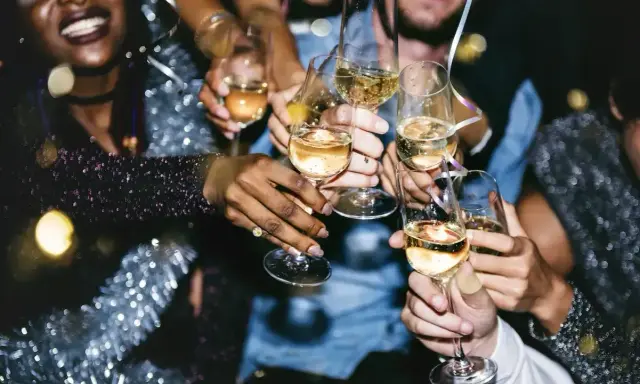 Radosna impreza, ludzie wznoszą kieliszki z szampanem. Po spożyciu alkoholu, pobranie krwi może dać inne wyniki.
