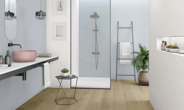Nowoczesna, biała łazienka z drewnianą podłogą, prysznicem walk-in i różową umywalką.