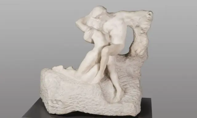 A marble sculpture of two embracing figures, a man lifting a woman, evoking Rodin's eternal spring of love and passion.