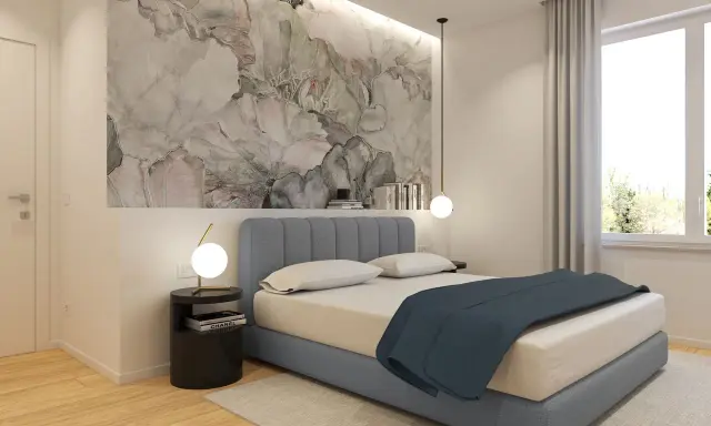 Idee per cosa mettere su un comò in camera da letto: un tavolino nero con lampada, libri e un vaso con fiori secchi.