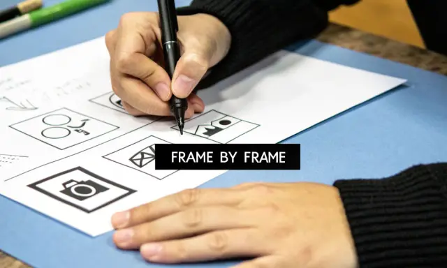 Mano dibujando bocetos de iconos en papel, como una cámara y un sobre. El texto "FRAME BY FRAME" aparece en un recuadro negro.