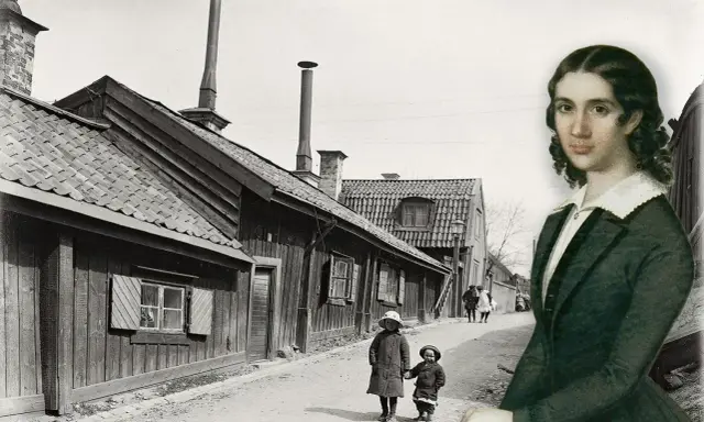 En kvinna, kanske Wendela Hebbe, betraktar en gammal svensk stadsgata med barn som leker.