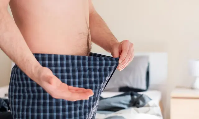 Mann mit Karo-Boxershorts, der sich fragt, ob Rauchstopp Potenz Erfahrungen positiv beeinflusst.