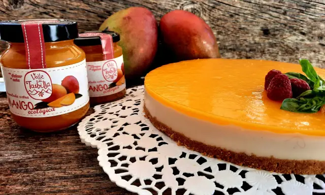 Deliciosa tarta de mango y queso, con mermelada ecológica de mango y frambuesas frescas.