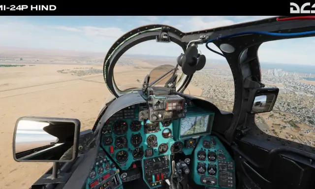 Widok z kokpitu Mi-24P Hind w DCS World Steam Edition. Lądujemy w pobliżu miasta nad pustynią.