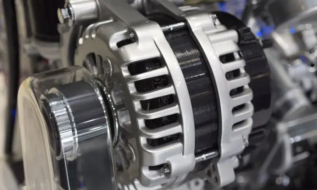 Błyszczący alternator w aucie, kluczowy element układu elektrycznego, gotowy do ładowania akumulatora.