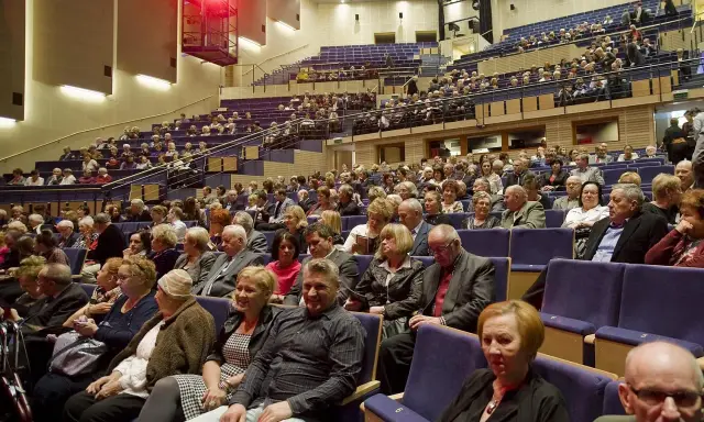 Widownia filharmonii w eleganckich strojach. Zastanawiasz się, jak się ubrać do filharmonii? Tutaj widzisz przykład klasycznych stylizacji.