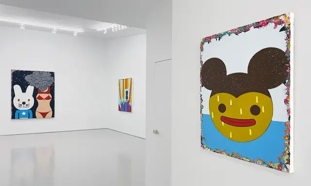 A gallery showcases vibrant paintings by Eli Klein. One features a cartoon rabbit and bikini-clad torso with smoke, another a colorful abstract, and a large piece with a yellow, Mickey Mouse-like face.