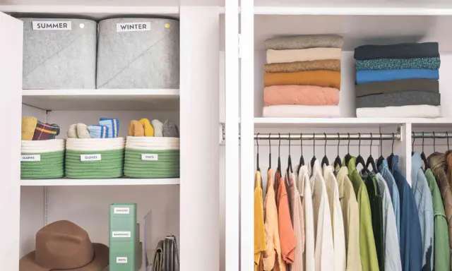 Closet with organized shelves: labeled bins for scarves, gloves, hats, jewelry, bandanas, belts, stacked sweaters, and hanging clothes.