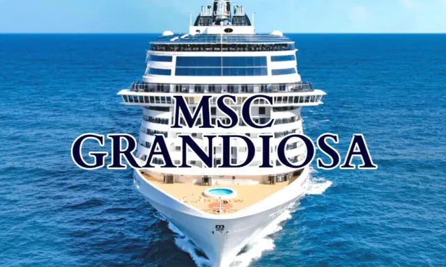 La MSC Grandiosa solca il mare blu, un gigante bianco con ponti che promettono avventure.