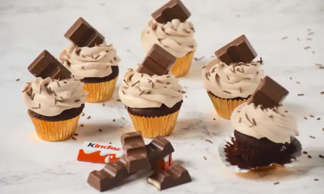 Cupcakes au chocolat avec ganache montée mascarpone, décorés de pépites et de barres Kinder. Un délice !