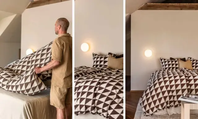 Gustav Ovland bäddar en säng med ett mönstrat påslakan. Sängen är bäddad med kuddar och ett täcke med geometriskt mönster.