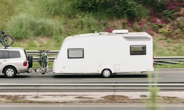 Un coche remolca una caravana blanca con bicicletas en la parte trasera. ¿Qué remolque puedo llevar con el carnet C?
