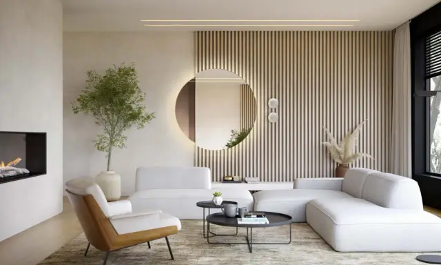 Okrągłe lustro w salonie, podświetlone od tyłu, odbija wnętrze. Obok niego pionowe lamele i nowoczesna sofa.