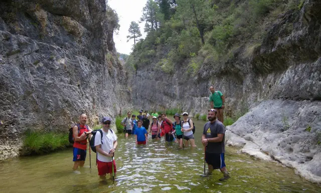 Grupo de senderistas disfrutando de un refrescante baño en el río, un lugar ideal donde bañarse en Yeste.
