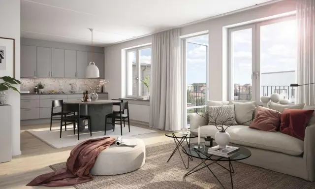 A bright, modern living room and kitchen with a dining table, sofa, and large windows.