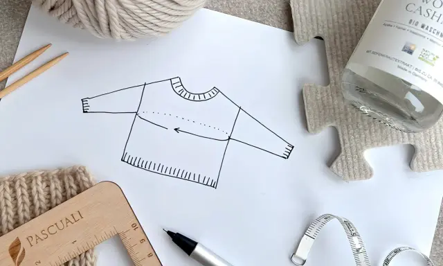 Esquema de jersey con medidas, ovillo de lana, agujas, cinta métrica y regla. Ideal para un top crochet tutorial.