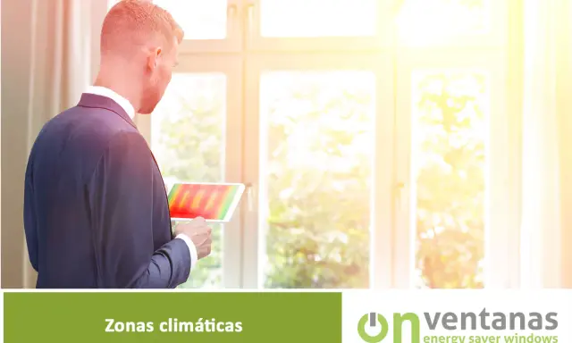 Hombre revisa tablet con mapa térmico, analizando la **zona climática** para optimizar el aislamiento de ventanas.