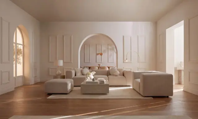 Salon lumineux aux murs beiges et moulures. Le mobilier, aussi beige, crée une ambiance douce. Quel couleur va avec le beige ? Le bois du parquet apporte une touche chaleureuse.