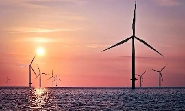Windräder im Meer bei Sonnenuntergang. Ein Symbol für die EEG Umlage Befreiung und eine saubere Zukunft.