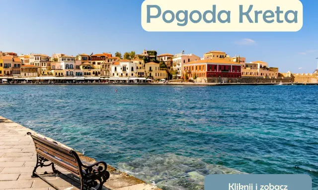Słoneczna pogoda na Krecie w lipcu. Widok na port z kolorowymi kamienicami i ławką nad turkusową wodą.