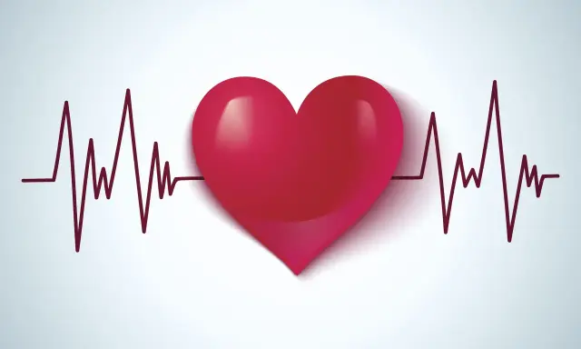 Czerwone serce na tle wykresu EKG. Symbolizuje zdrowie, życie i walkę z wadami serca, takimi jak np. VSD.