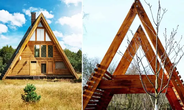 Une maison en A, en bois, se dresse dans un champ d'herbes hautes. Une autre structure triangulaire en bois, avec un arbre nu, est visible à droite.