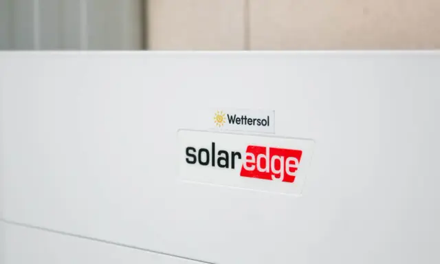 En vit enhet med logotyper för Wetter sol och solaredge optimerare.